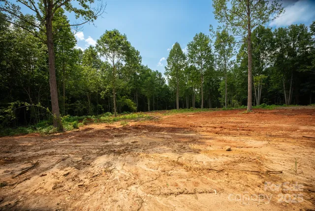 a swimming pool with trees in the background