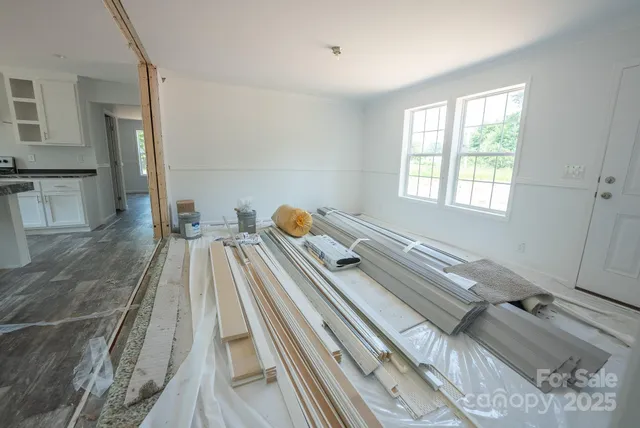 a kitchen with stainless steel appliances granite countertop a sink a stove a refrigerator and island with wooden floor