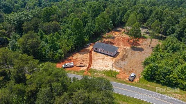 an aerial view of a house with yard swimming pool and outdoor seating