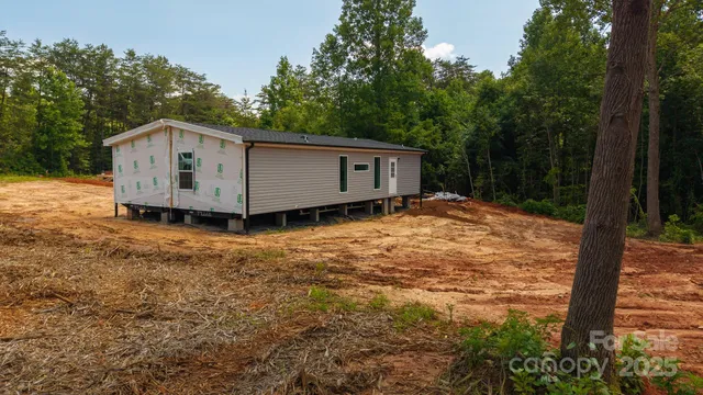 a backyard of a house with wooden floor and fence