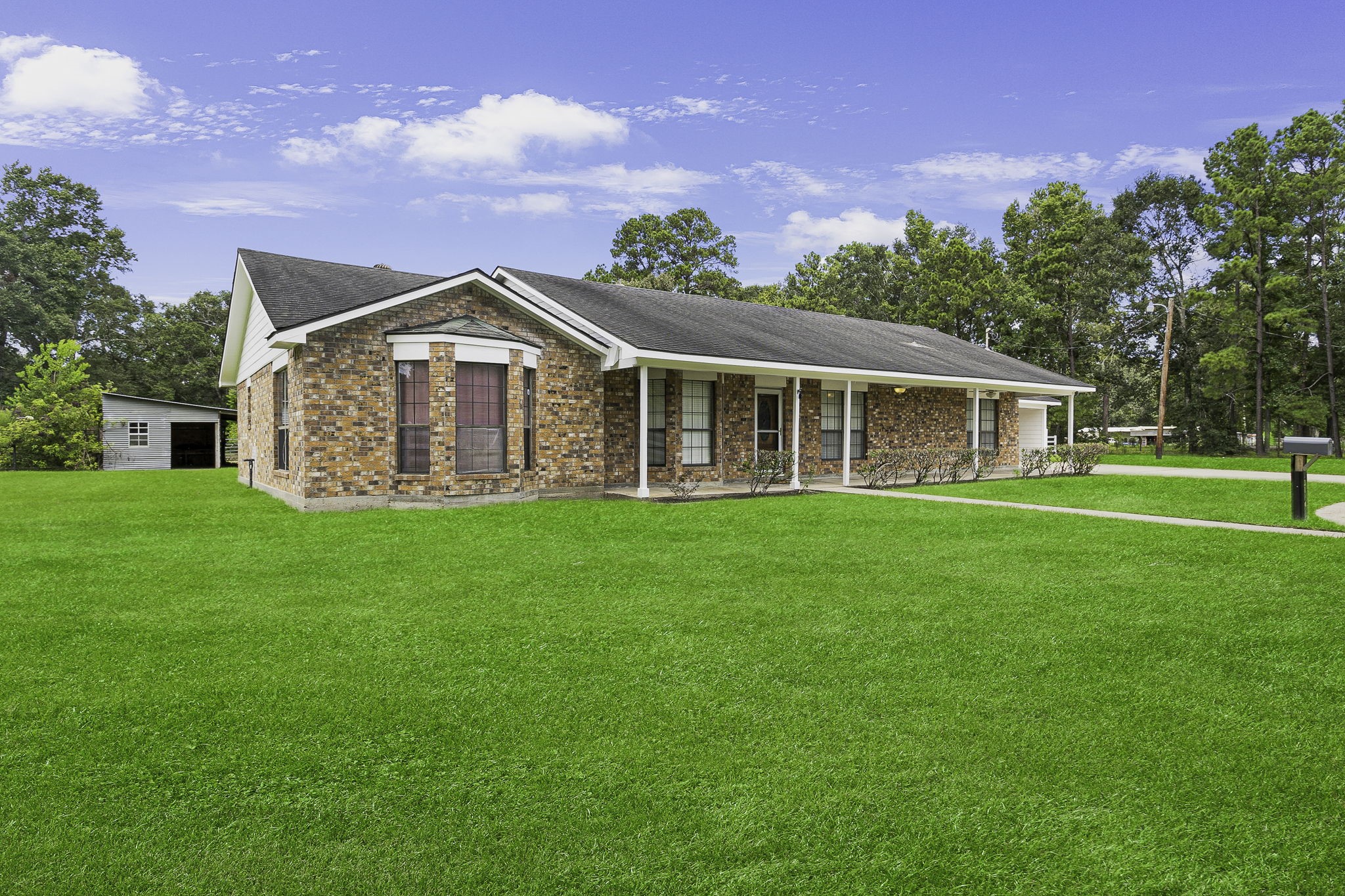 a front view of a house with a garden