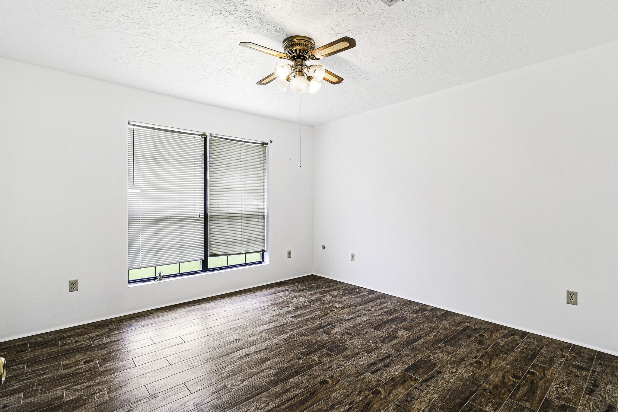 13180 Morgan Drive Splendora, TX 77372 - Photo 16 of 34 an empty room with wooden floor and windows