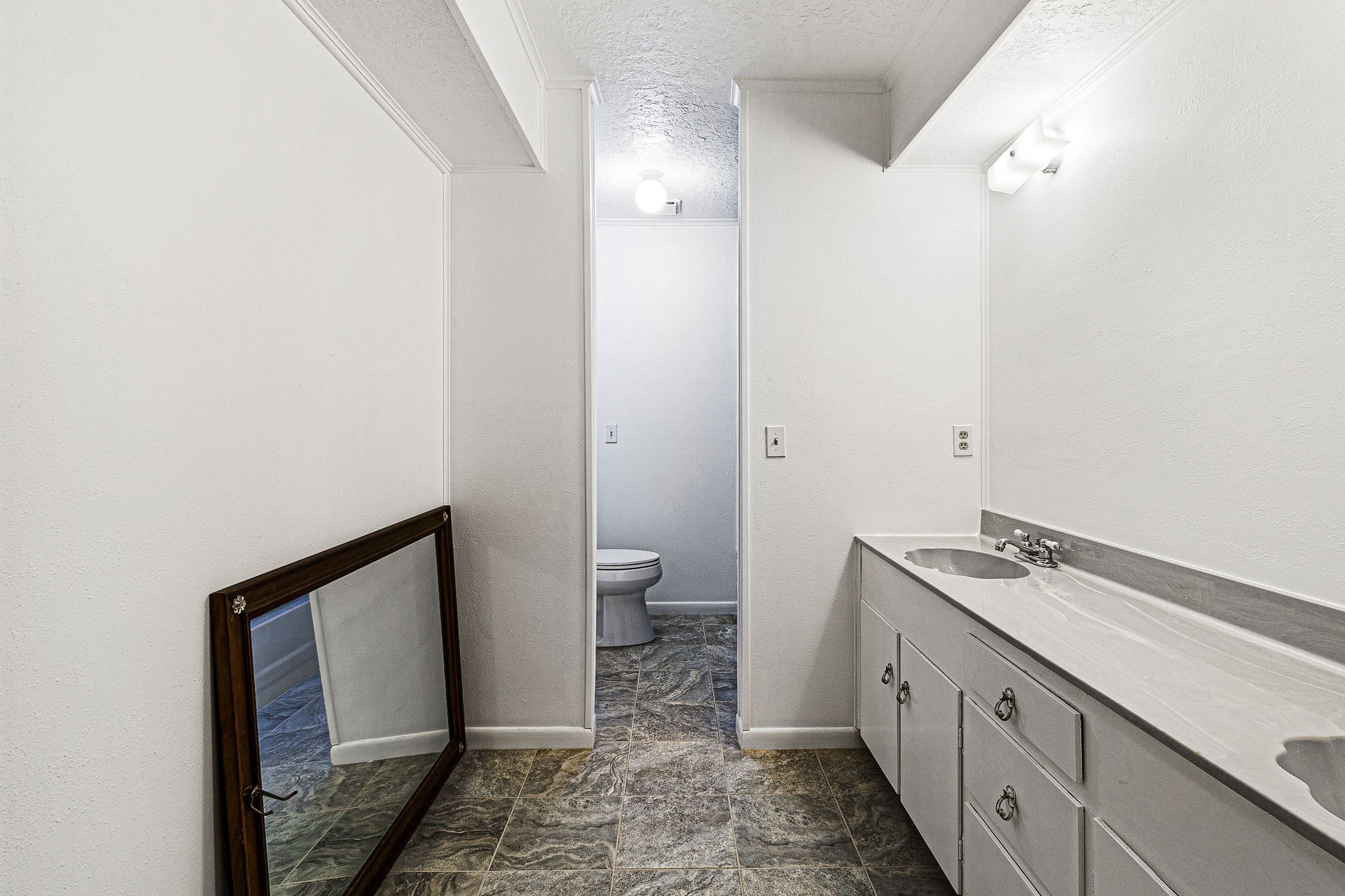 13180 Morgan Drive Splendora, TX 77372 - Photo 17 of 34 a bathroom with a granite countertop sink and a mirror