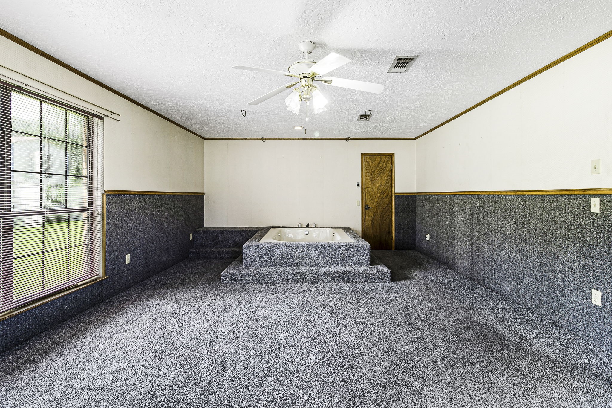 13180 Morgan Drive Splendora, TX 77372 - Photo 21 of 34 a spacious bedroom with a bed and a chandelier