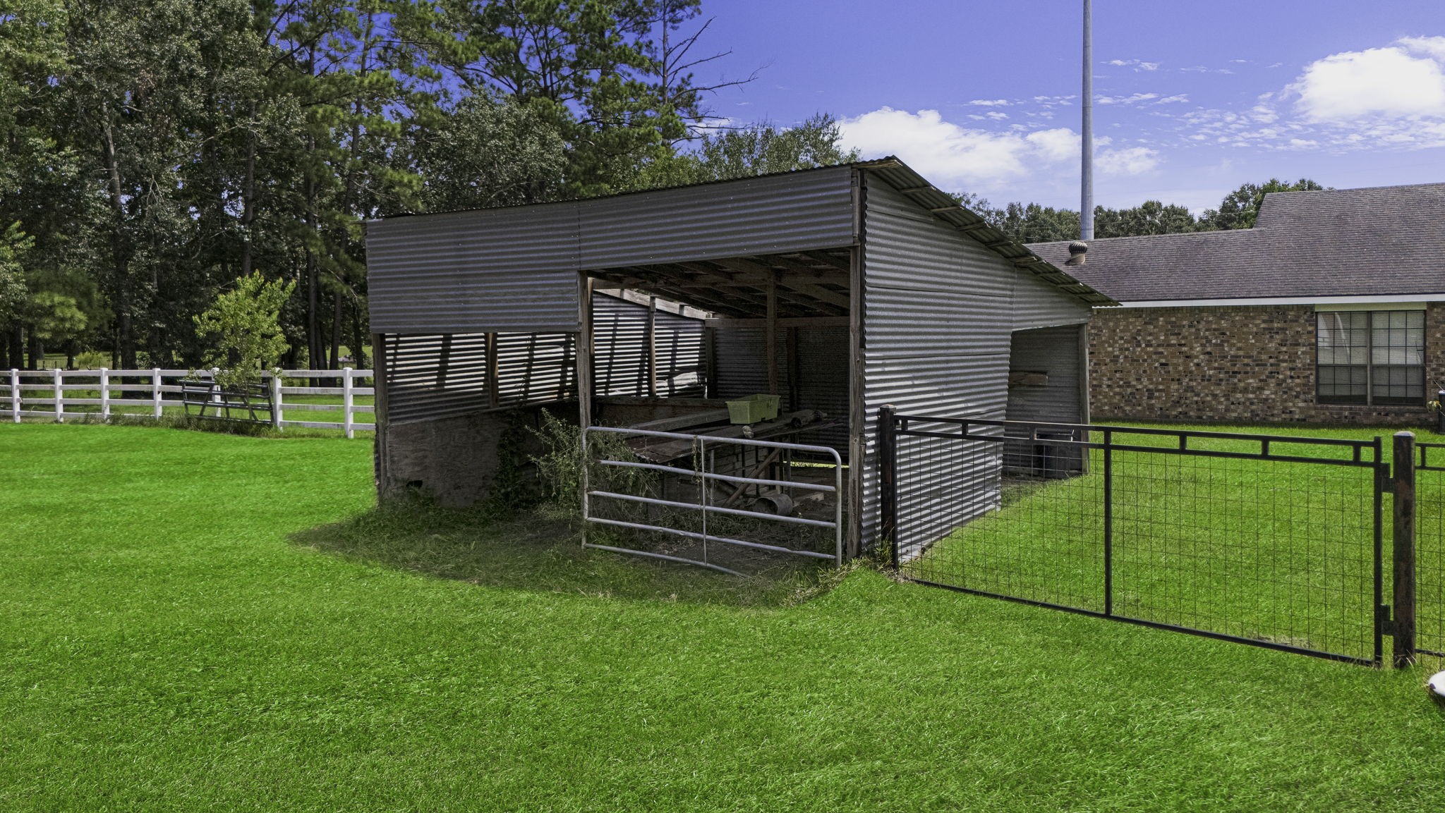 13180 Morgan Drive Splendora, TX 77372 - Photo 26 of 34 a view of a house with a yard