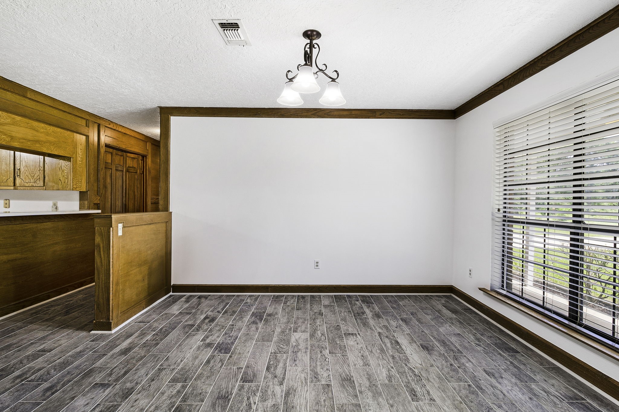 13180 Morgan Drive Splendora, TX 77372 - Photo 10 of 34 a view of an empty room with wooden floor and a window
