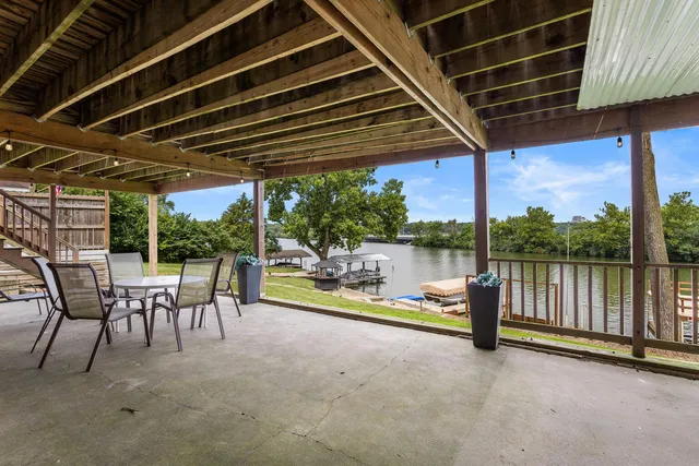 a view of a porch with furniture and a backyard