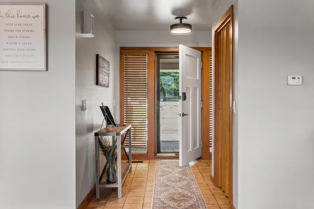 a view of a hallway with furniture and windows