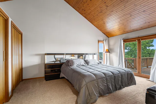 a bedroom with a bed and a large window