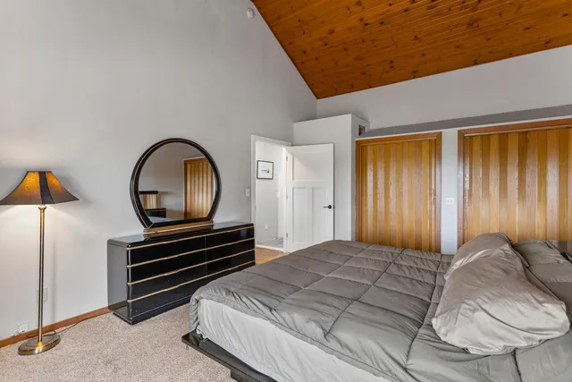 a bedroom with a bed and a chandelier