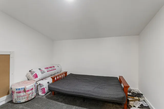 a bedroom with a bed and a shelf