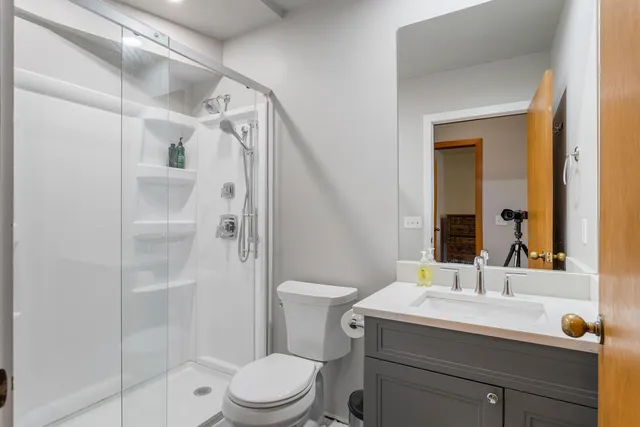 a bathroom with a sink toilet and shower