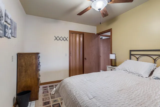 a bedroom with a bed and a chandelier