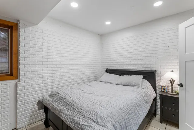 a bedroom with a bed and a lamp