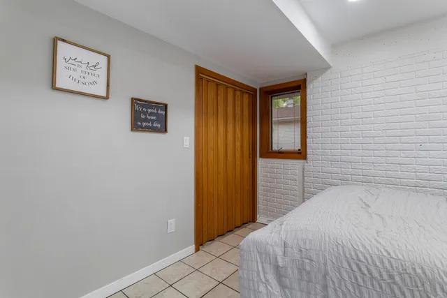 a bedroom with a bed and a wall painting