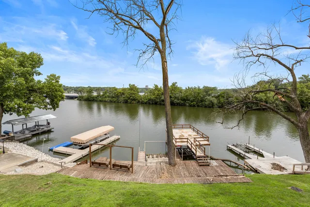 a lake view with a bench under an umbrella