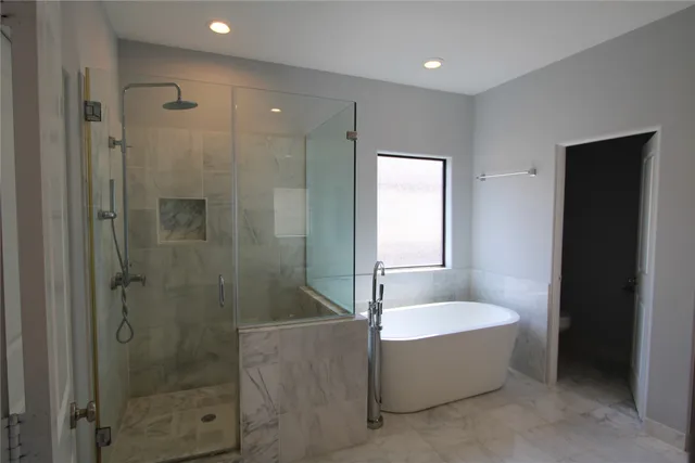 a bathroom with a bathtub and shower