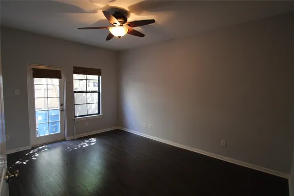 a view of wooden floor and a chandelier fan in a room