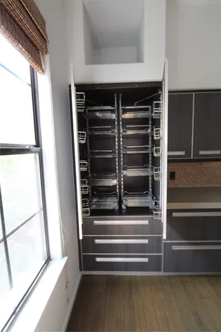 a view of walk in closet with empty racks