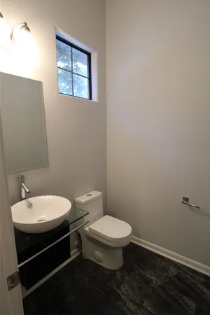 a white toilet sitting next to a bathroom sink