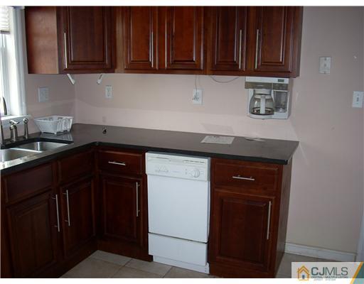 183 Old Post Road Edison, NJ 08817 - Photo 3 of 8 a kitchen with granite countertop wood cabinets and a sink