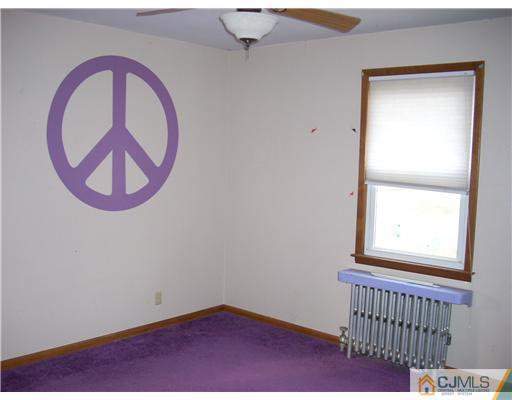 183 Old Post Road Edison, NJ 08817 - Photo 7 of 8 a view of a room with wooden floor and a window