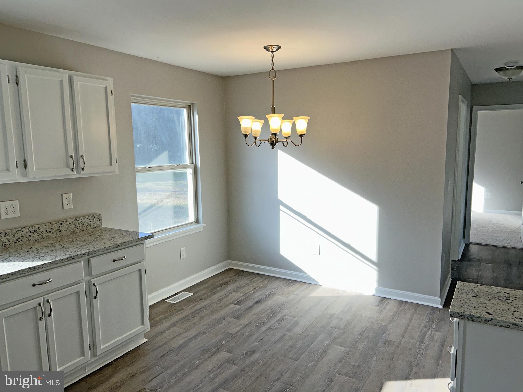 21630 Hackney Circle Lincoln, DE 19960 - Photo 4 of 13 a kitchen with stainless steel appliances granite countertop a refrigerator a sink dishwasher a stove and white cabinets with wooden floor