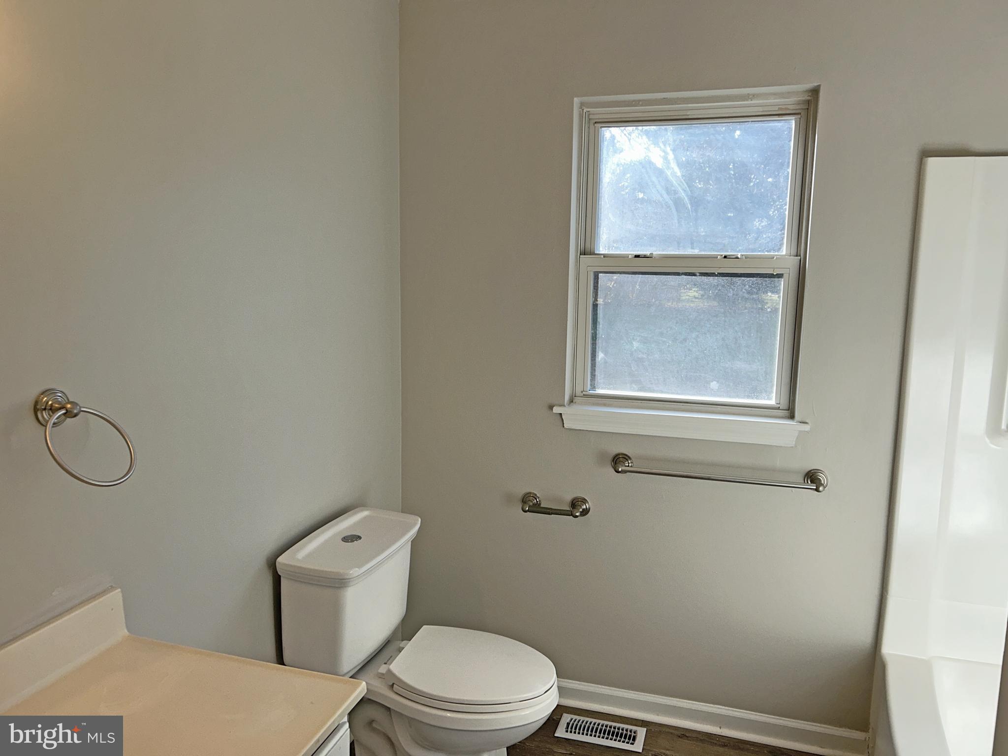 21630 Hackney Circle Lincoln, DE 19960 - Photo 9 of 13 a white toilet sitting next to a bathroom sink