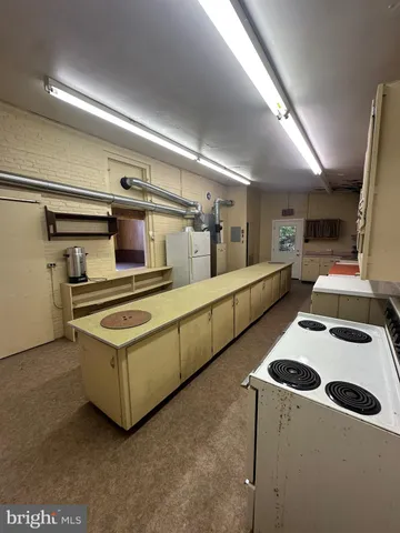 a kitchen with stainless steel appliances a sink a stove and a refrigerator