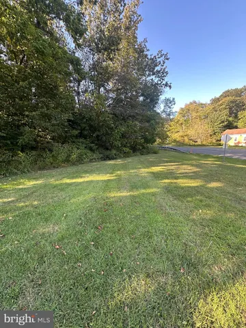 a view of a field of grass and trees