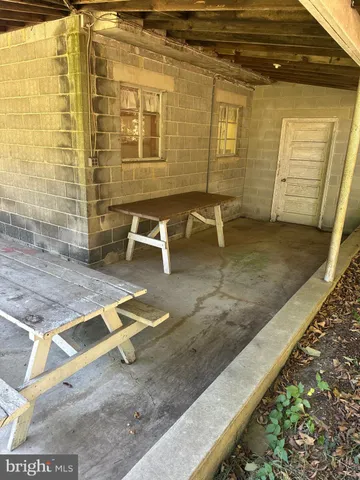a view of a patio with a table and chairs