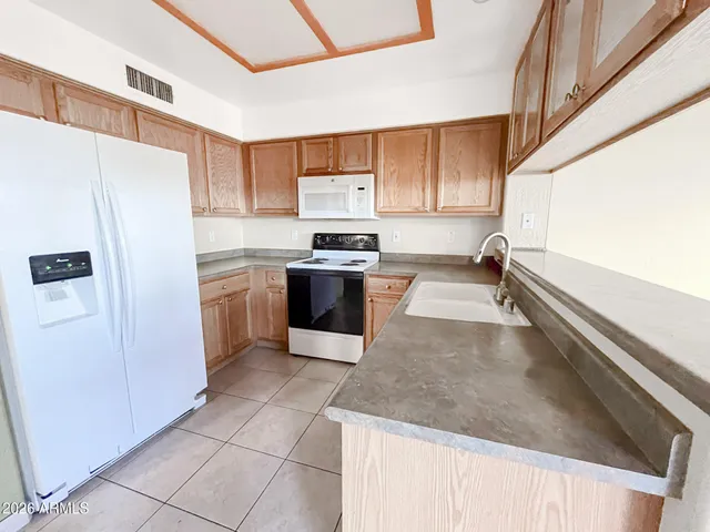 a view of empty room with windows and fireplace