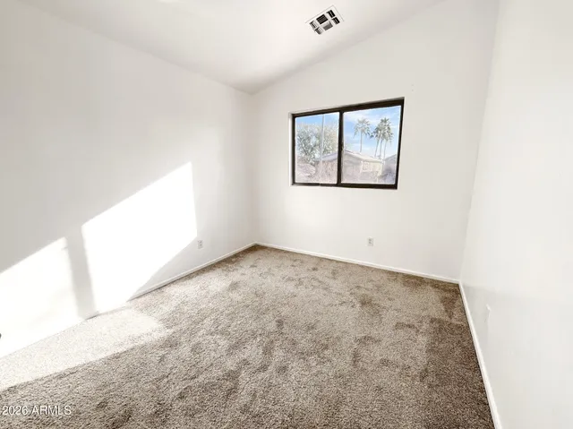 an empty room with a empty space and windows