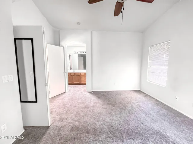 a white toilet and shower glass window