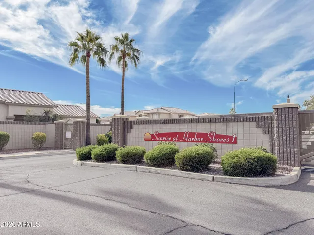 a view of a house with a big yard and palm trees