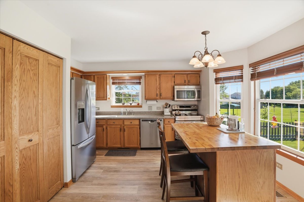 3413 Harbor Ridge Drive Zion, IL 60099 - Photo 15 of 37 a kitchen with kitchen island a large counter top space appliances and cabinets