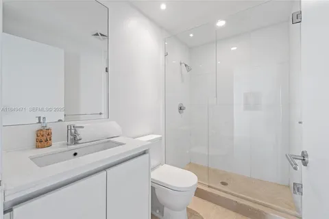 a bathroom with a sink toilet and shower