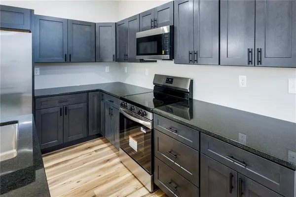 a kitchen with sink cabinets and stainless steel appliances