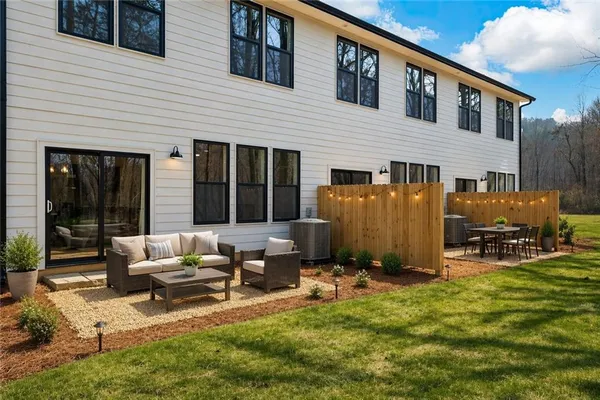 a backyard of a house with table and chairs