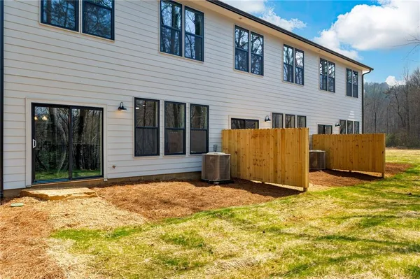 a view of a house with backyard and a tree