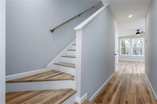 a view of entryway with wooden floor and stairs