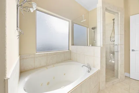 a en suite bathroom with a double vanity sink and a mirror
