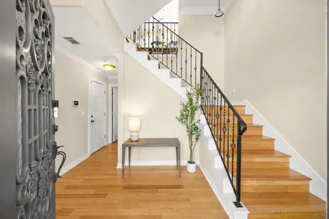 a view of entryway and hall with wooden floor