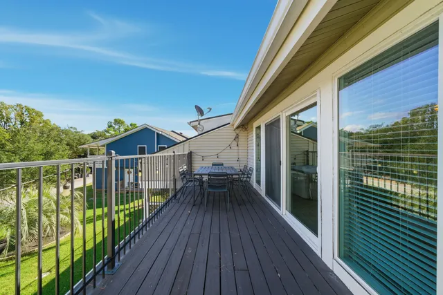 a view of a wooden deck and a backyard