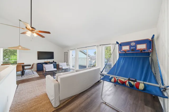 a living room with furniture and a chandelier