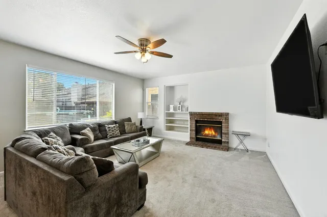 a living room with furniture and a large window