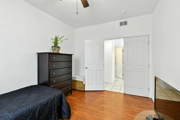 a bedroom with a bed and a ceiling fan