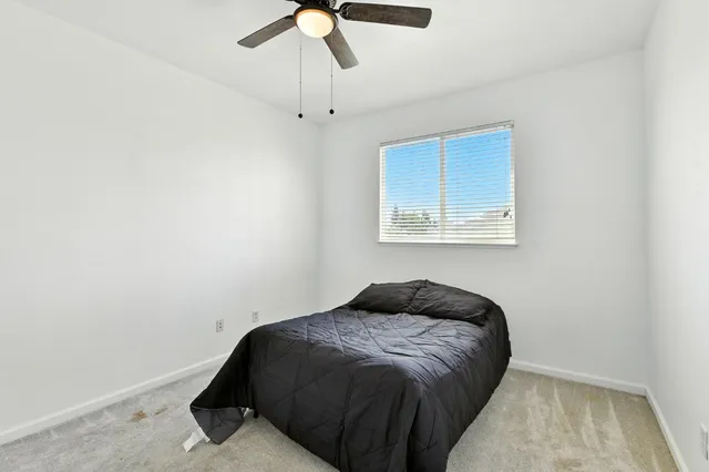 a bedroom with a bed and a window