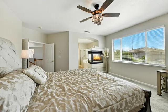 a bedroom with a large bed and a tv