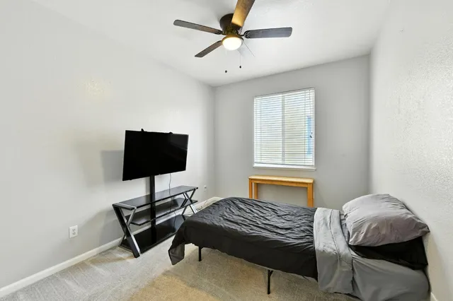 a bedroom with a bed and a window